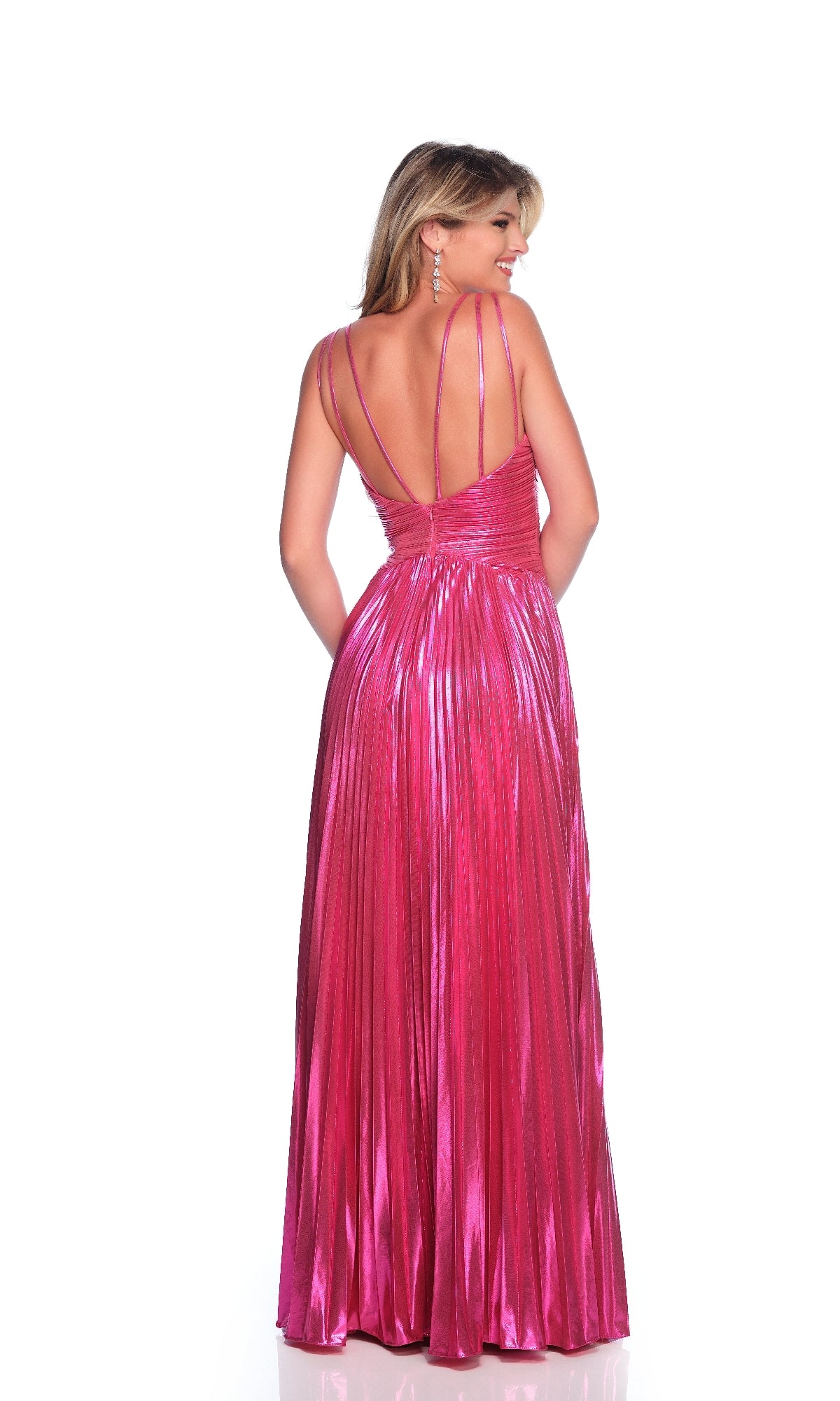 A woman faces away from the camera, wearing the Dave and Johnny 12078— a fuchsia pink prom dress with thin double straps, a shimmering finish, and a floor-length pleated skirt.